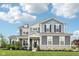 Beautiful two-story home with a manicured lawn and attractive landscaping at 3316 Shelborne Woods Pkwy, Carmel, IN 46032