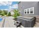 Relaxing hot tub on a patio with a gray house and manicured landscaping at 3316 Shelborne Woods Pkwy, Carmel, IN 46032