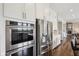 Gourmet kitchen with stainless steel appliances including double oven and refrigerator, and ample cabinet space at 3316 Shelborne Woods Pkwy, Carmel, IN 46032