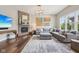 Bright living room with a fireplace, hardwood floors, and comfortable seating at 3316 Shelborne Woods Pkwy, Carmel, IN 46032