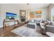 Living room features a cozy fireplace, hardwood floors, and ample seating at 3316 Shelborne Woods Pkwy, Carmel, IN 46032