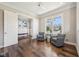 Bright office space with hardwood floors, natural light, and additional sitting area at 3316 Shelborne Woods Pkwy, Carmel, IN 46032