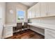 Well-lit office space with hardwood floors, two desks, and ample storage with white cabinetry at 3316 Shelborne Woods Pkwy, Carmel, IN 46032