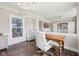 Bright office with hardwood floors, view to living room, and ample space for work or study at 3316 Shelborne Woods Pkwy, Carmel, IN 46032