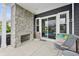 Covered stone patio with a fireplace, patio furniture, and view of the backyard and pool at 3316 Shelborne Woods Pkwy, Carmel, IN 46032