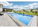 Backyard swimming pool and pergola with outdoor kitchen, surrounded by a green lawn at 3316 Shelborne Woods Pkwy, Carmel, IN 46032