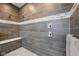 Walk-in shower features stone flooring, seating and decorative tile work at 3316 Shelborne Woods Pkwy, Carmel, IN 46032