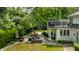 This backyard features an outdoor patio, seating area, and lush greenery, perfect for relaxing and entertaining at 410 Somerset W Dr, Indianapolis, IN 46260