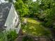 This home has a spacious, fenced backyard with mature trees, a manicured lawn, and a patio area for outdoor enjoyment at 410 Somerset W Dr, Indianapolis, IN 46260