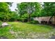 Spacious backyard with lush greenery, well-manicured lawn, and mature trees at 410 Somerset W Dr, Indianapolis, IN 46260