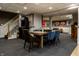 Finished basement with gaming and sports decor, stairs to main floor at 410 Somerset W Dr, Indianapolis, IN 46260