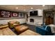 Finished basement with a large fireplace, flat screen TV, and comfortable seating at 410 Somerset W Dr, Indianapolis, IN 46260