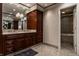 Bathroom with granite countertops, wood cabinets, dual sinks, and a walk-in shower at 410 Somerset W Dr, Indianapolis, IN 46260
