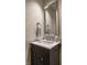 Stylish bathroom vanity featuring a marble countertop and a decorative mirror at 410 Somerset W Dr, Indianapolis, IN 46260