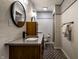 Modern bathroom with a wood vanity, oval mirror, and walk-in shower at 410 Somerset W Dr, Indianapolis, IN 46260