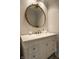 Elegant bathroom featuring a marble sink vanity, designer mirror, and upscale fixtures at 410 Somerset W Dr, Indianapolis, IN 46260