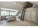 Spacious bedroom featuring a ladder to the loft, multiple windows, and neutral tones at 410 Somerset W Dr, Indianapolis, IN 46260