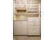 Custom closet with white shelving, cabinets and drawers with gold hardware at 410 Somerset W Dr, Indianapolis, IN 46260