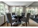 Open-concept dining area featuring hardwood floors and an abundance of natural light at 410 Somerset W Dr, Indianapolis, IN 46260