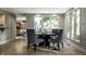 Dining area featuring hardwood floors and large windows at 410 Somerset W Dr, Indianapolis, IN 46260