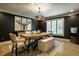Stylish dining room with modern lighting and a large window at 410 Somerset W Dr, Indianapolis, IN 46260