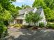Charming two-story home with a well-manicured lawn, beautiful landscaping, and an inviting front porch at 410 Somerset W Dr, Indianapolis, IN 46260