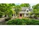 Charming two-story home with brick-paved porch and a beautifully landscaped front yard at 410 Somerset W Dr, Indianapolis, IN 46260