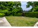 Well-maintained front yard features a lush green lawn and mature trees at 410 Somerset W Dr, Indianapolis, IN 46260