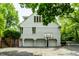 Garage exterior featuring three garage doors, brick accents, and a basketball hoop at 410 Somerset W Dr, Indianapolis, IN 46260