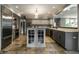 Modern kitchen showcasing stainless steel appliances, granite countertops, and tiled flooring at 410 Somerset W Dr, Indianapolis, IN 46260