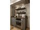Custom kitchen featuring a stainless steel oven, modern shelving, and tiled flooring at 410 Somerset W Dr, Indianapolis, IN 46260