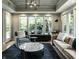 Stylish living room with an area rug, large windows, and a modern light fixture at 410 Somerset W Dr, Indianapolis, IN 46260