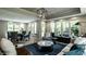 Open-concept living room featuring hardwood floors, large windows, and elegant decor at 410 Somerset W Dr, Indianapolis, IN 46260