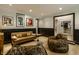 Spacious living room featuring designer couch, soft chairs, and modern entryway to staircase at 410 Somerset W Dr, Indianapolis, IN 46260