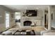 Bright living room with hardwood floors, brick fireplace and modern furnishings at 410 Somerset W Dr, Indianapolis, IN 46260