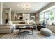 Open-concept living room with built-in storage, and a large bay window providing natural light at 410 Somerset W Dr, Indianapolis, IN 46260