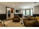 Inviting living room with unique chairs, hardwood floors, and a view into another room at 410 Somerset W Dr, Indianapolis, IN 46260