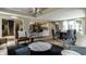 Open-concept living space with a wet bar, dining area, and a seamless transition to the kitchen at 410 Somerset W Dr, Indianapolis, IN 46260