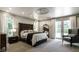 Spacious primary bedroom with large bed, accent chair, and elegant finishes at 410 Somerset W Dr, Indianapolis, IN 46260