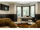 Bright home office featuring a large window, desk, and stylish decor at 410 Somerset W Dr, Indianapolis, IN 46260
