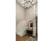 Traditional white staircase featuring wainscoting and a modern chandelier at 410 Somerset W Dr, Indianapolis, IN 46260