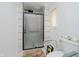Bright bathroom featuring a glass door shower, white horizontal tile and toilet at 4232 Linden Ln, Anderson, IN 46011