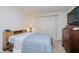 Comfortable bedroom with a bed, dresser, carpet, and window with curtains at 4232 Linden Ln, Anderson, IN 46011