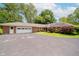 Ranch home featuring a brick exterior, attached garage, and spacious driveway at 4232 Linden Ln, Anderson, IN 46011