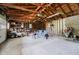 Spacious garage with exposed wood framing, storage, and a riding lawn mower at 4232 Linden Ln, Anderson, IN 46011