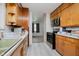Functional kitchen with wooden cabinetry, microwave, and view to the next room at 4232 Linden Ln, Anderson, IN 46011