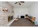 Bright living room featuring stone fireplace and ceiling fan at 4232 Linden Ln, Anderson, IN 46011