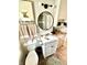 Well-lit bathroom with white fixtures, a decorative mirror, and charming details at 4714 Crestview Ave, Indianapolis, IN 46205