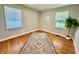 Well-lit bedroom with hardwood floors and a geometric patterned rug at 4714 Crestview Ave, Indianapolis, IN 46205