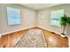Bright bedroom with hardwood floors, two windows, and neutral decor at 4714 Crestview Ave, Indianapolis, IN 46205
